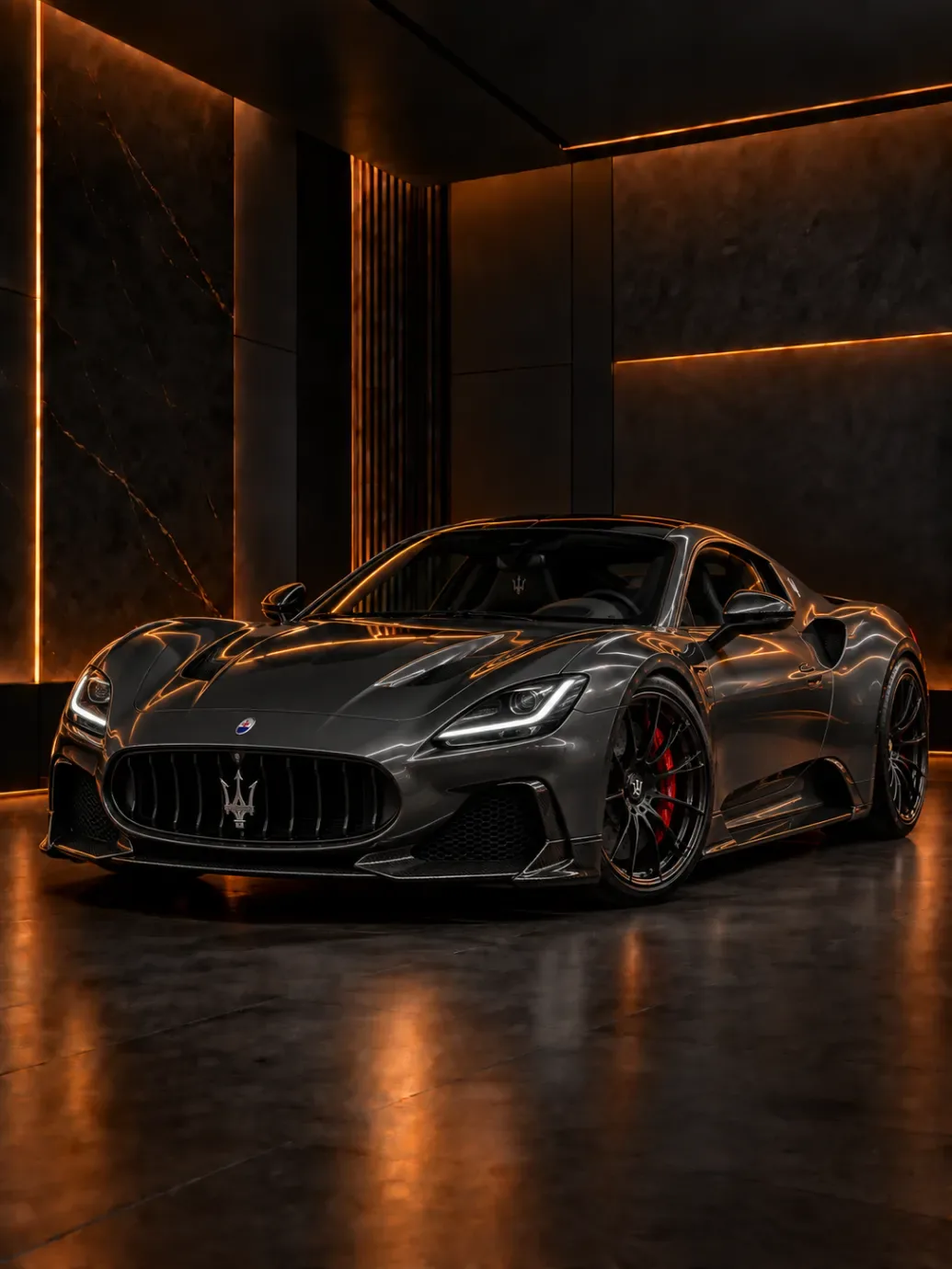 Dark grey Maserati sports coupe with trident grille and red brake calipers