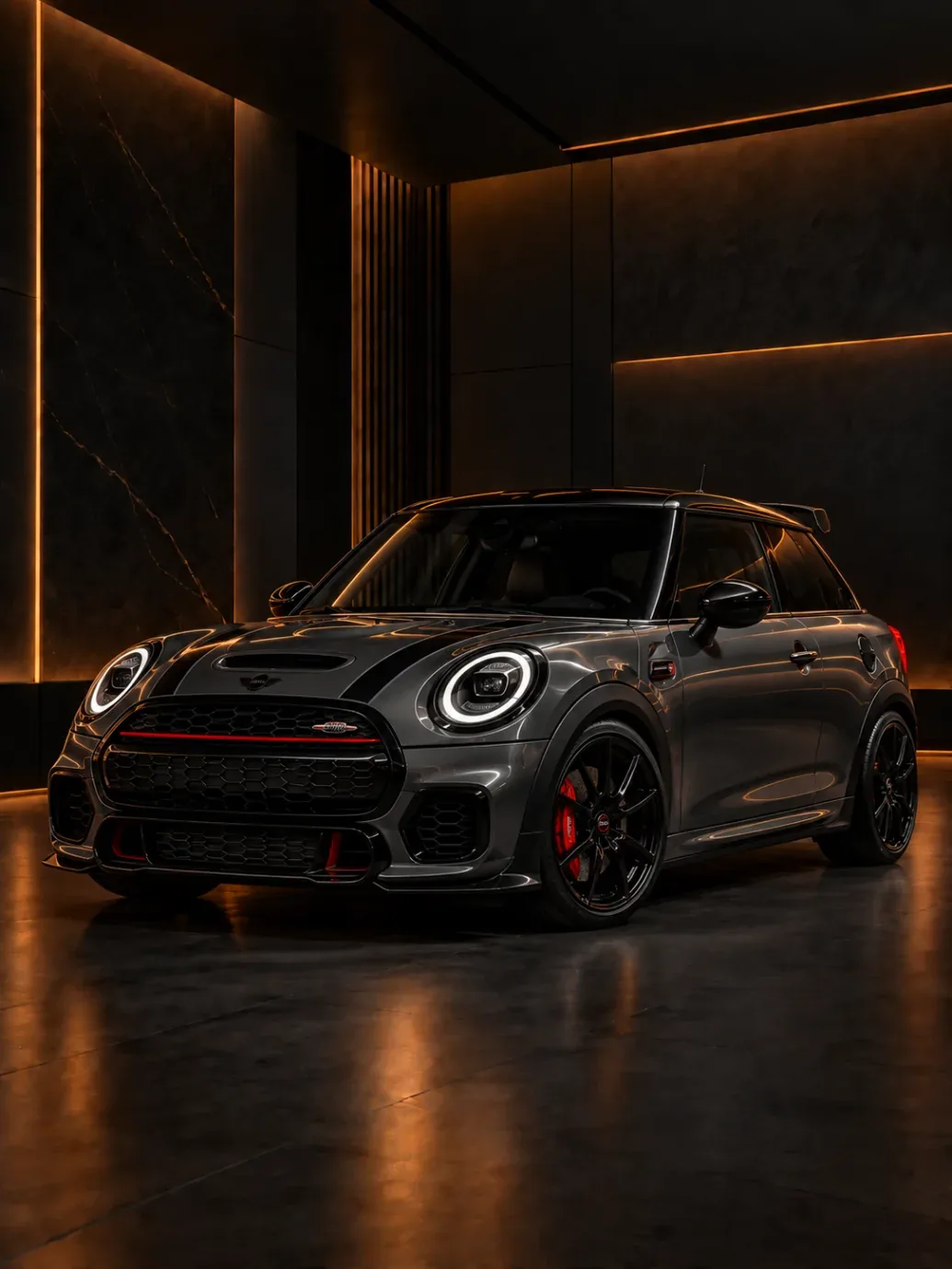 Dark grey MINI Cooper hatchback with a red grille stripe and red calipers
