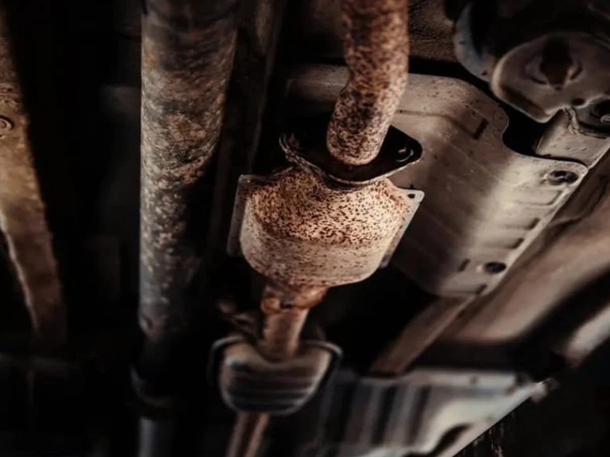 Rusted catalytic converter and exhaust pipe under a car