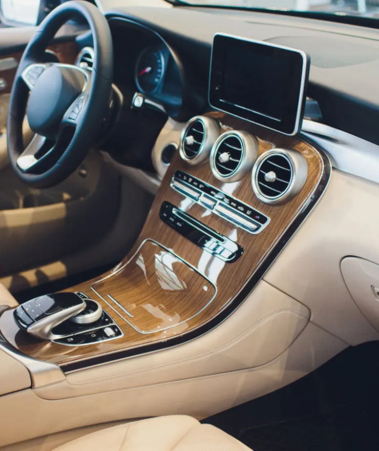 Luxury car dashboard with a wood-trim centre console and touchscreen