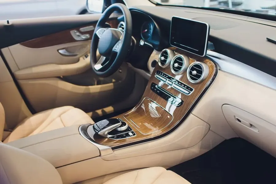 Cream leather seats and wood-trimmed dashboard in a luxury car interior