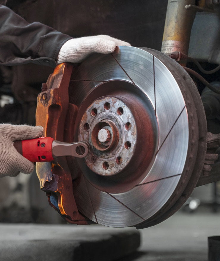Mechanic performing car brake pad replacement in Dubai at Royal Prince Auto Care Garage.